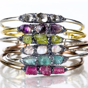 custom birthstone stacked bracelet on white background, pink stone, green stone, white stone, blue stone, purple stone